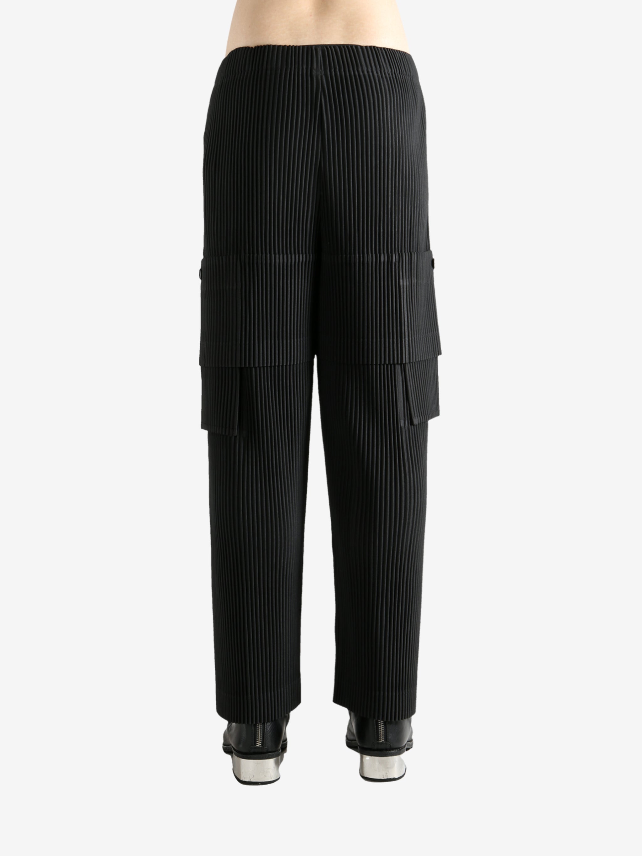 Black pants worn by a person, showing the pant's fit