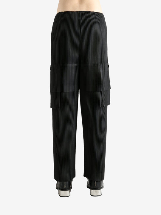 Black pants worn by a person, showing the pant's fit