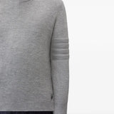 Grey knitwear worn by a person, showing the knitwear fit