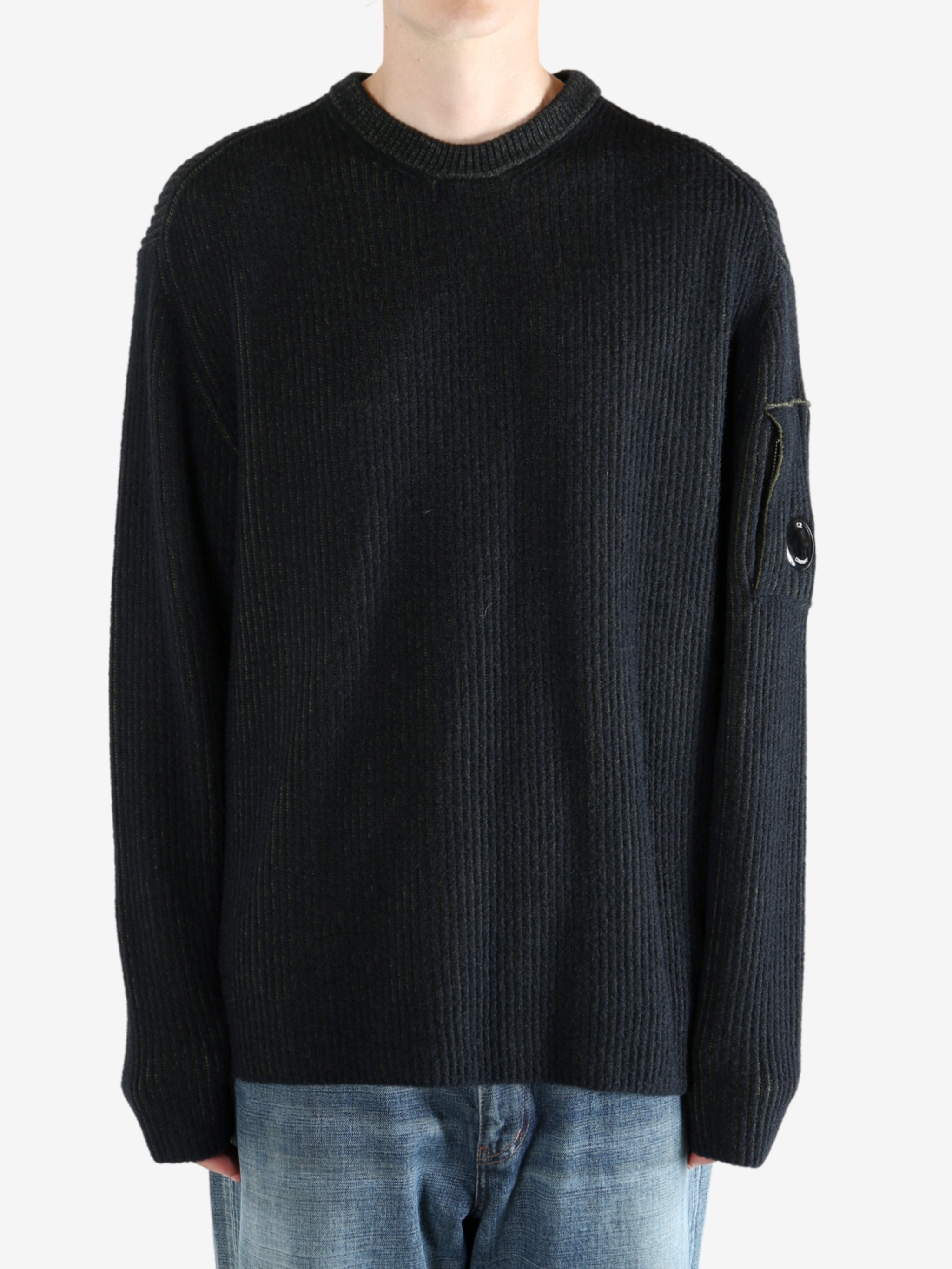 Black sweater worn by a person, showing the sweater fit