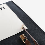 Close up of black bag, showing texture of the leather fabric