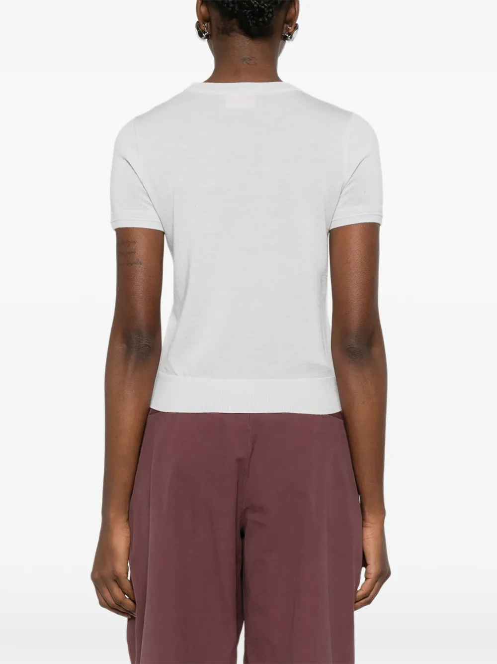 white knitwear worn by a person, showing the knitwear fit