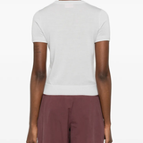 white knitwear worn by a person, showing the knitwear fit