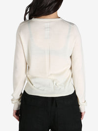 White sweater worn by a person, back view