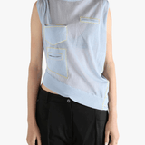 Blue vest worn by a person, showing the loose fit.