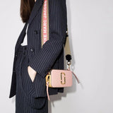 Pink bag worn by a person, showing the bag's fit