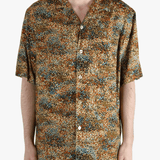 Tan shirt worn by a person, showing the fit