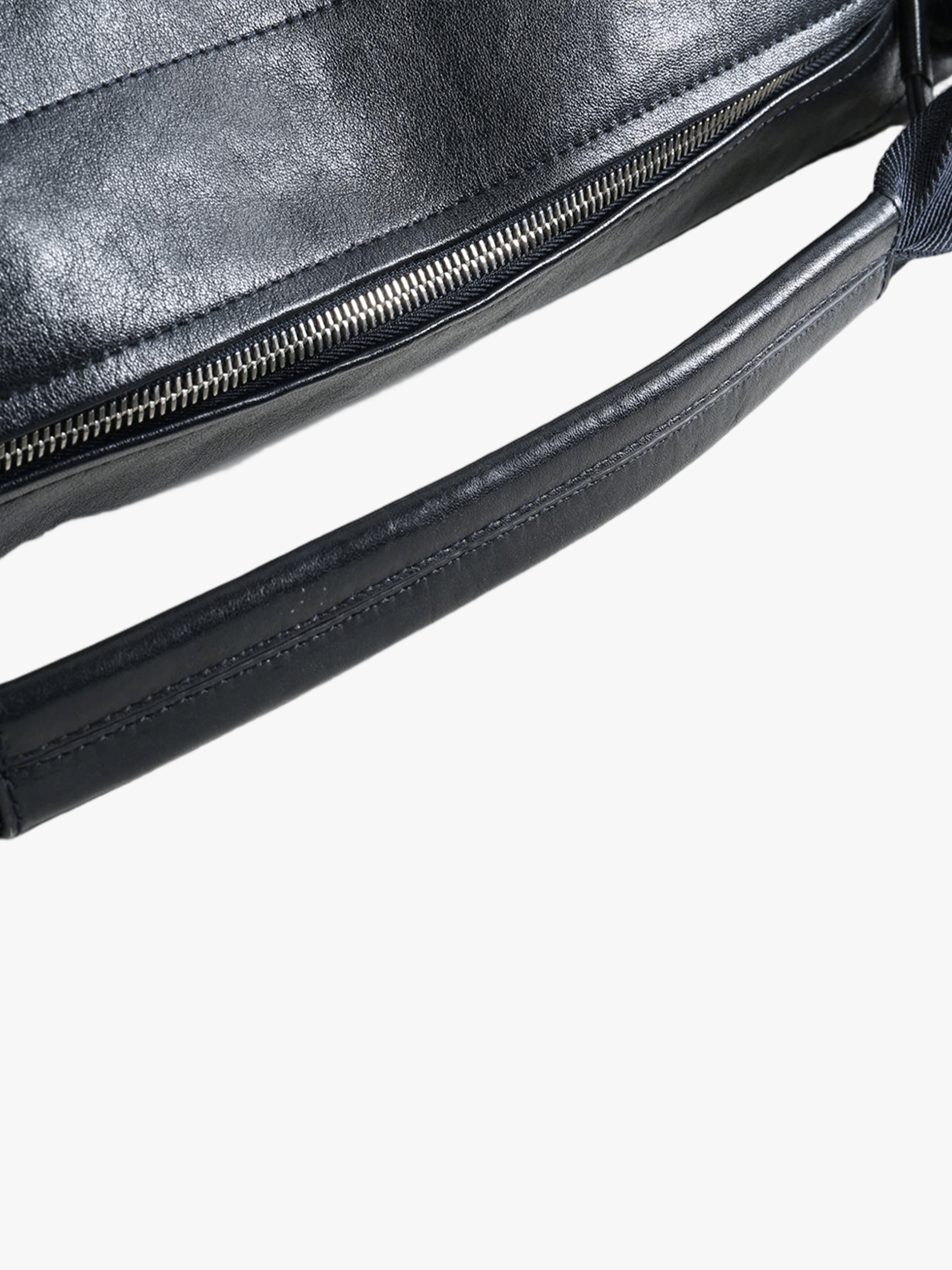 Close up of black bag, showing texture of the leather fabric