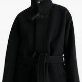 Black coat worn by a person, showing the coat's fit