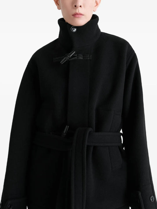 Black coat worn by a person, showing the coat's fit