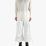 White shirt worn by a person, showing the shirt's fit