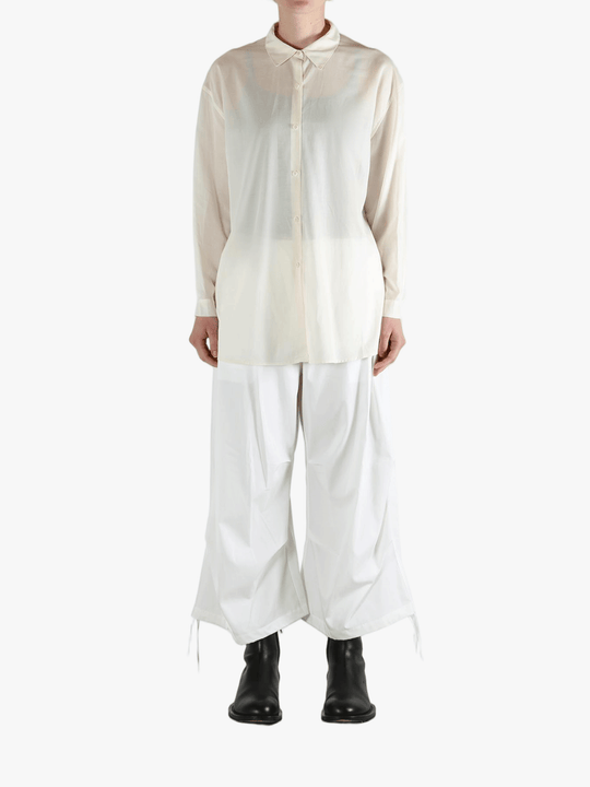 White shirt worn by a person, showing the shirt's fit