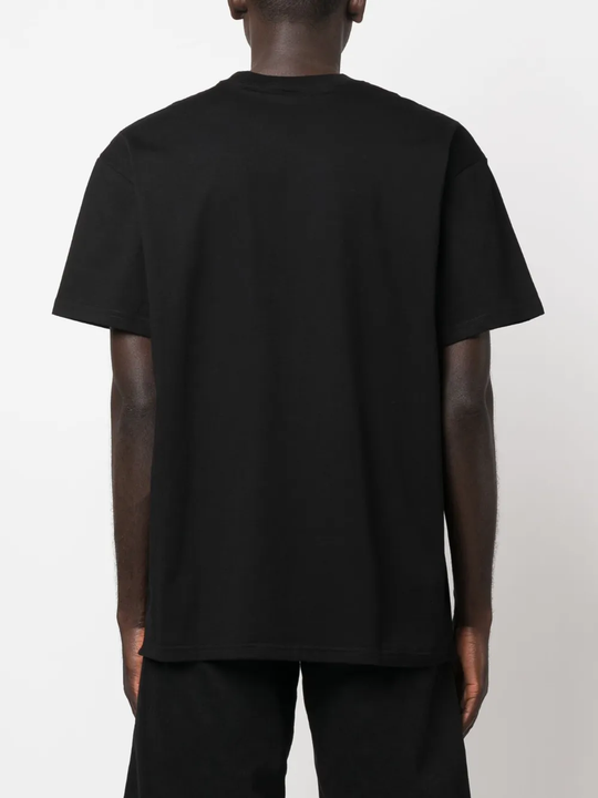 Black t-shirt worn by a person, showing the shirt's fit