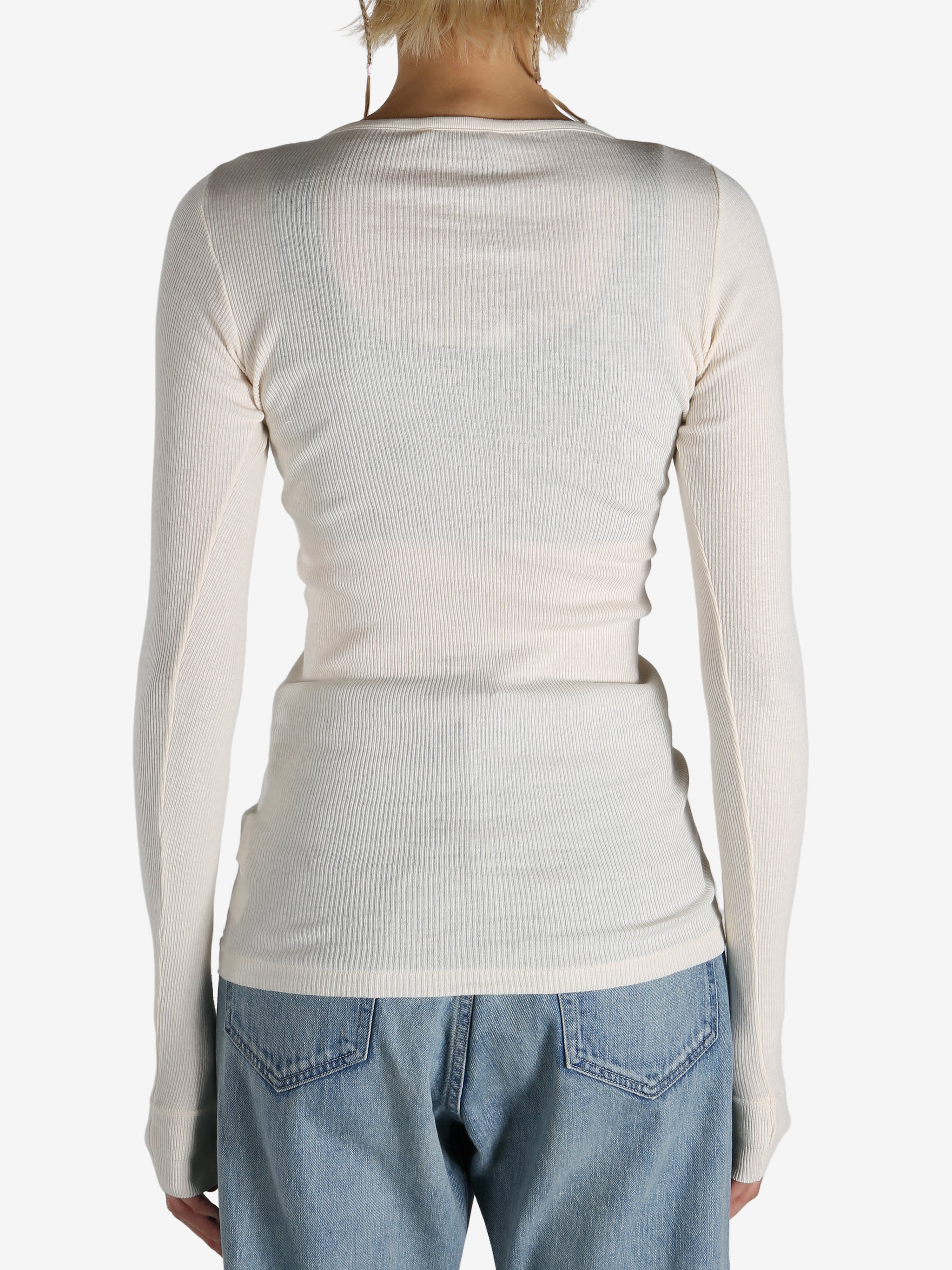 White T-shirt worn by a person, showing the shirt's fit