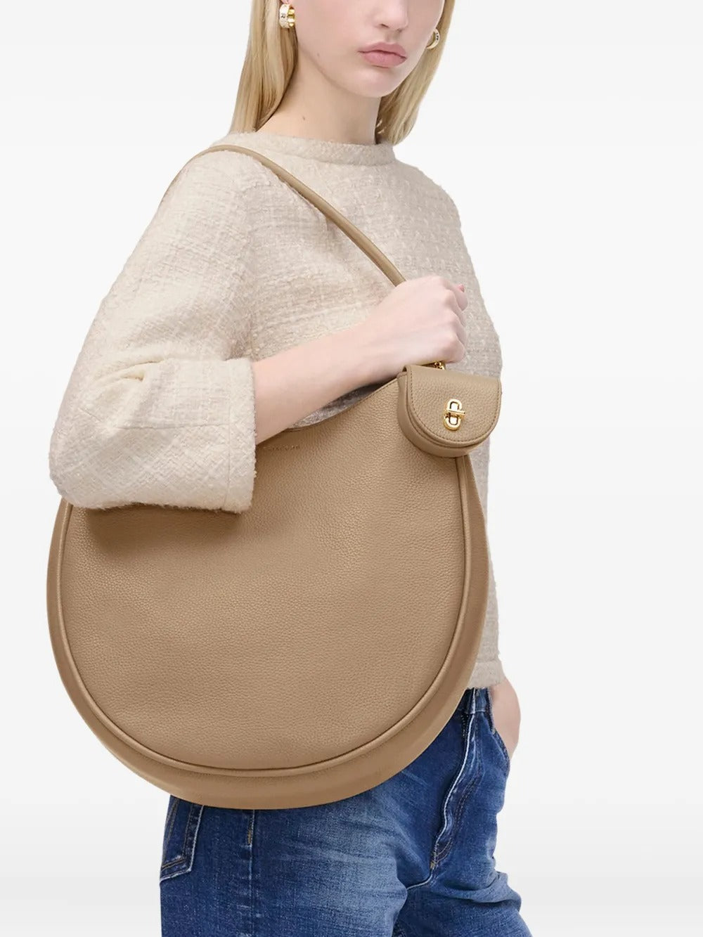 Tan bag worn by a person, showing the bag's fit