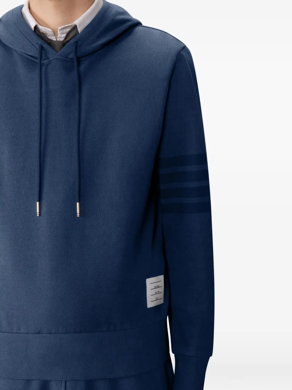 Close up of navy hoodie, showing texture of the Cotton fabric