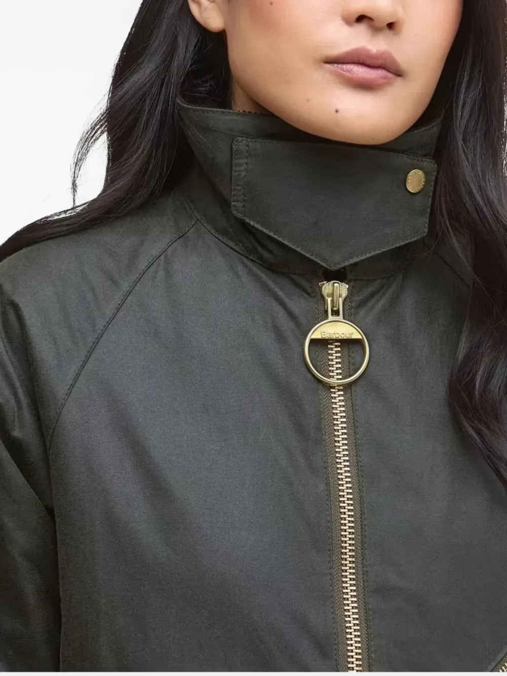 Green jacket worn by a person, showing the jacket fit
