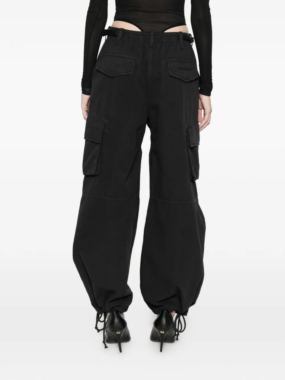 black pants worn by a person, showing the pants fit