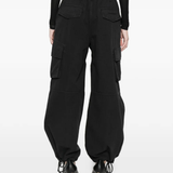 black pants worn by a person, showing the pants fit