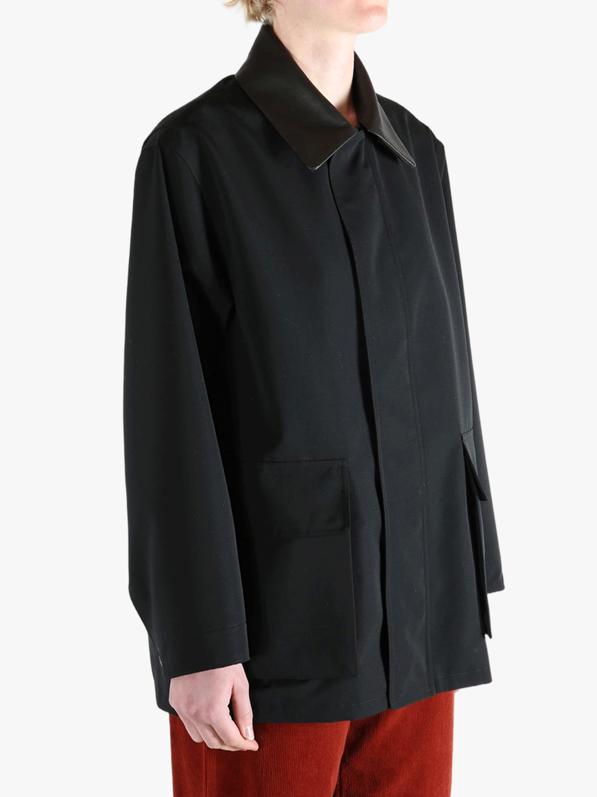 Black jacket worn by a person, showing the jackets fit