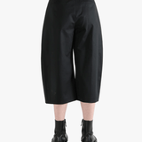 Black pants worn by a person, showing the pants' fit
