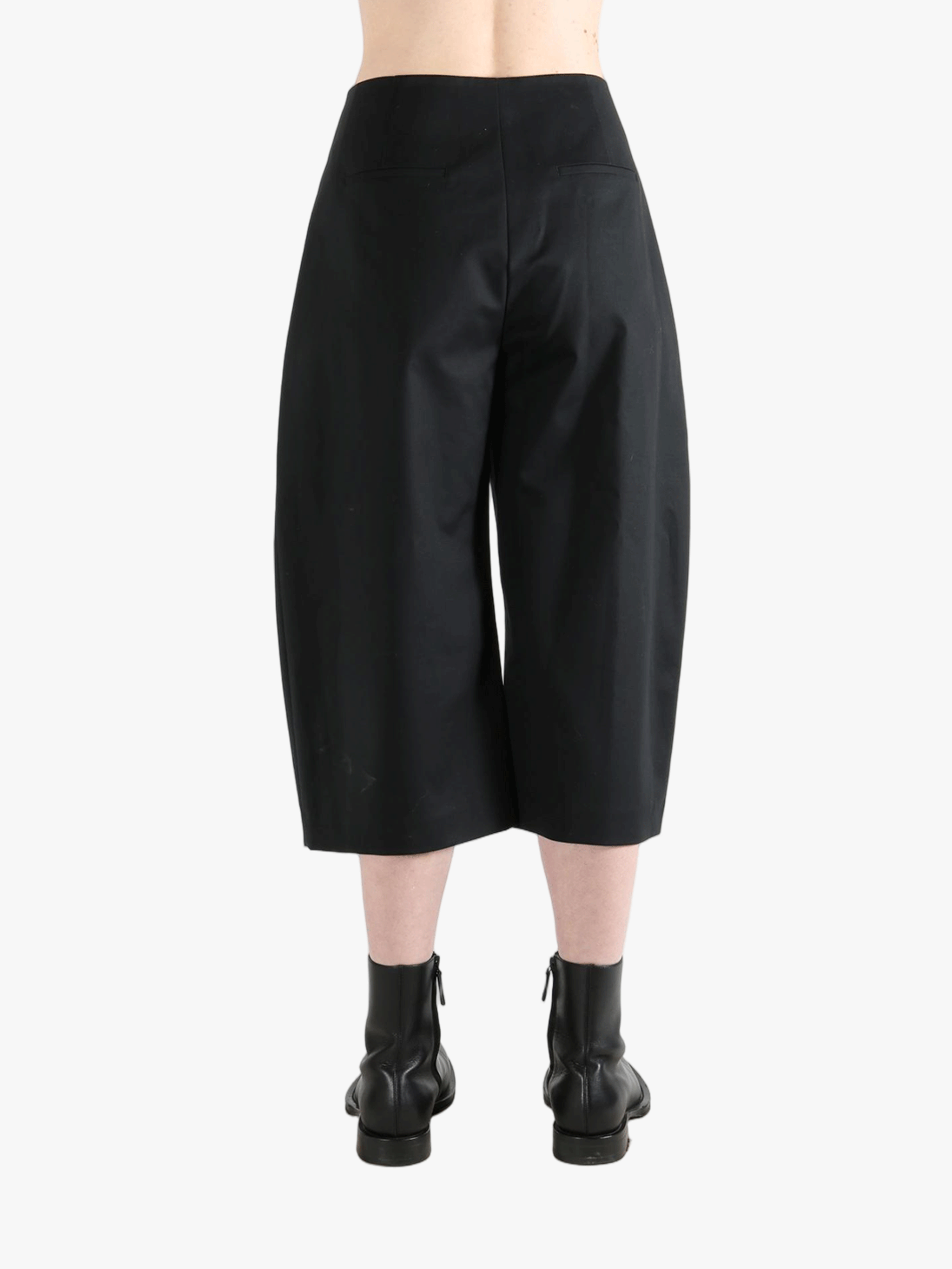 Black pants worn by a person, showing the pants' fit