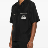 Black shirt worn by a person, showing the shirt's fit