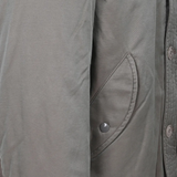 Close up of grey jacket, showing texture of the Cotton and Nylon fabric