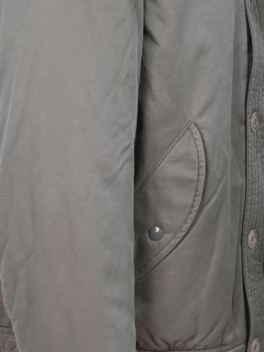 Close up of grey jacket, showing texture of the Cotton and Nylon fabric