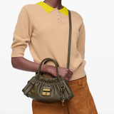 Green bags worn by a person, showing the bags fit