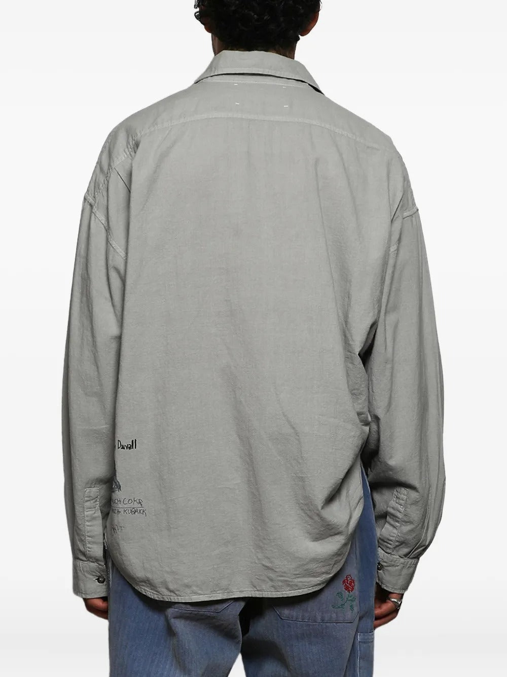 Grey shirts worn by a person, showing the shirts fit