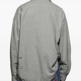 Grey shirts worn by a person, showing the shirts fit