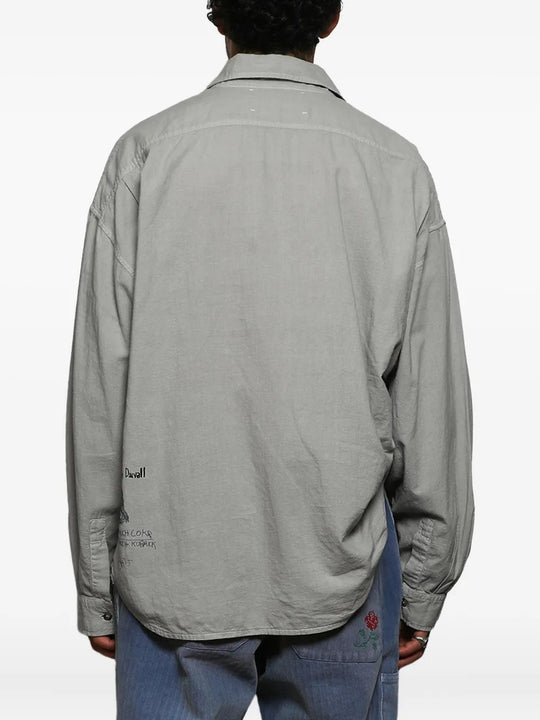 Grey shirts worn by a person, showing the shirts fit