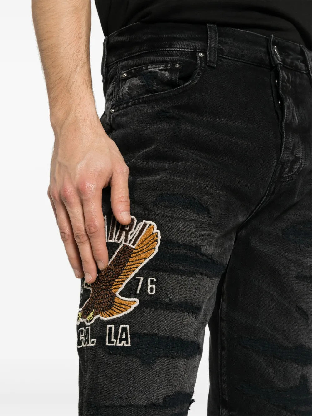 Black jeans worn by a person, showing the jeans fit