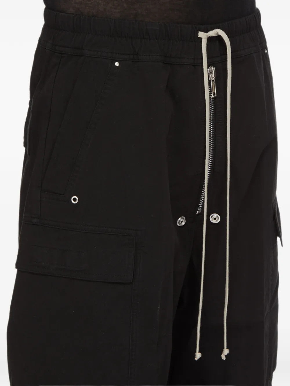 Black pants worn by a person, showing the pants fit
