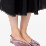 Pink flat sandal worn by a person, showing the sandal fit