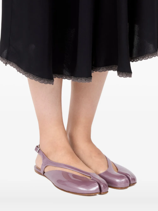 Pink flat sandal worn by a person, showing the sandal fit