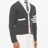 Grey knitwear worn by a person, showing the knitwear fit