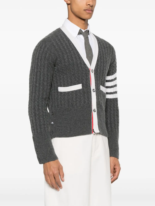 Grey knitwear worn by a person, showing the knitwear fit