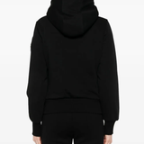 Black coat worn by a person, showing the coat fit