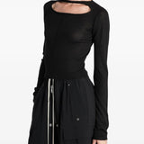 Black top worn by a person, showing the top fit