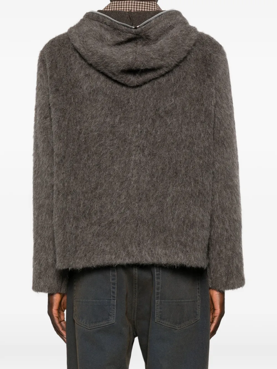 grey hoodie worn by a person, showing the hoodie fit