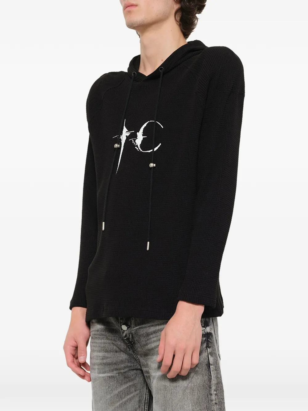 Black hoodie worn by a person, showing the hoodie fit