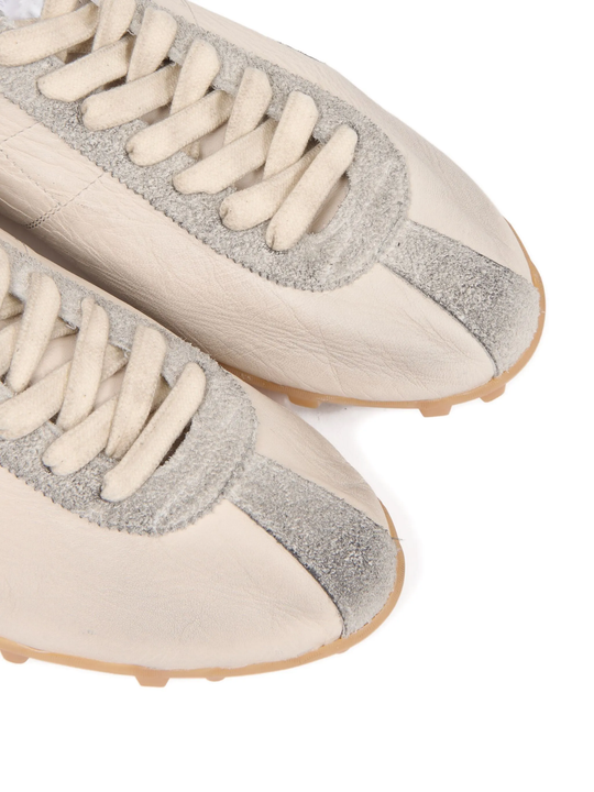 Close up of tan sneakers, showing texture of the Polyester fabric