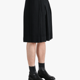 Black pants worn by a person, showing the  pants fit