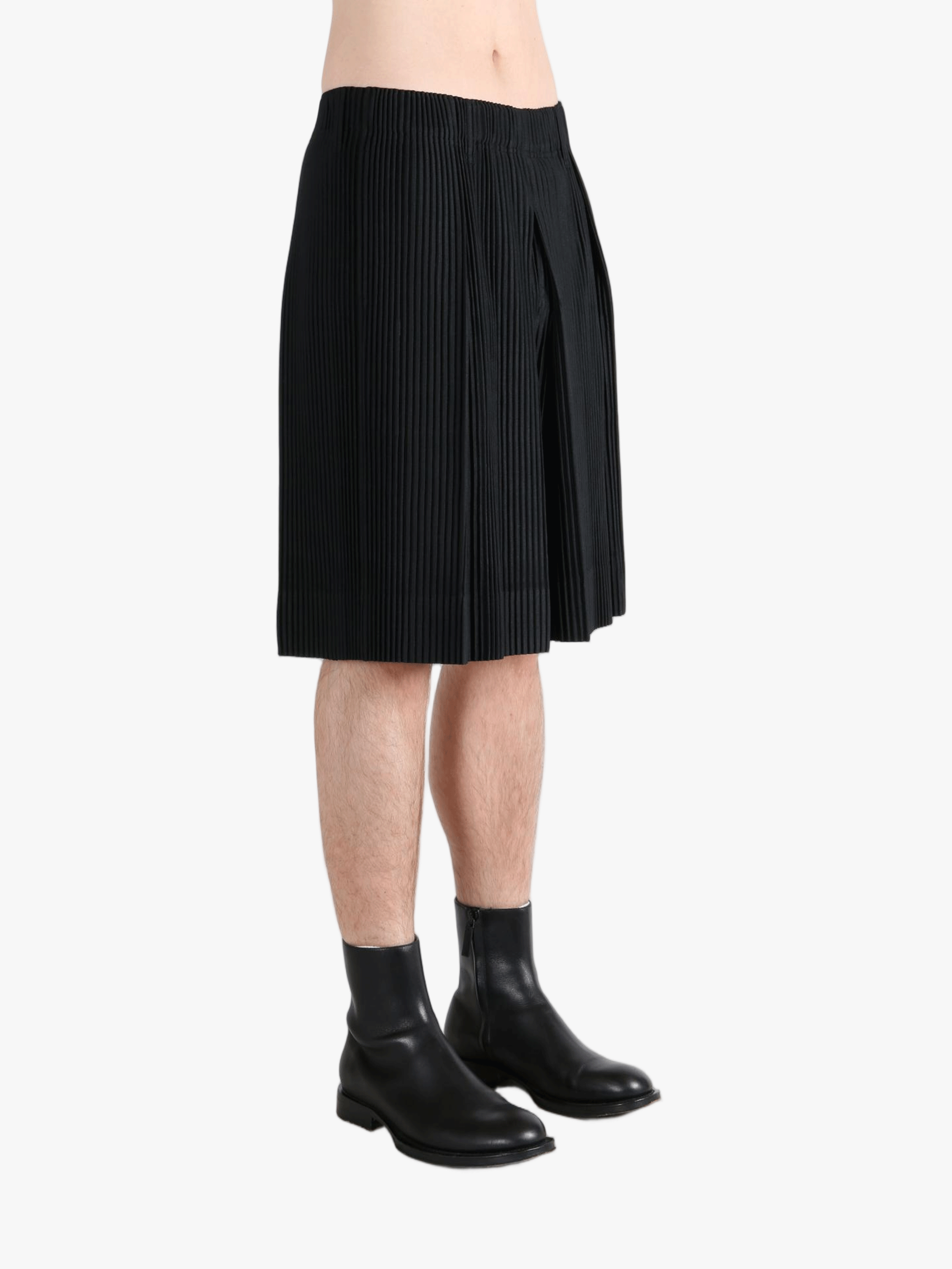 Black pants worn by a person, showing the  pants fit