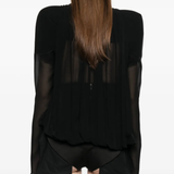 Black jacket worn by a person, showing the jacket fit