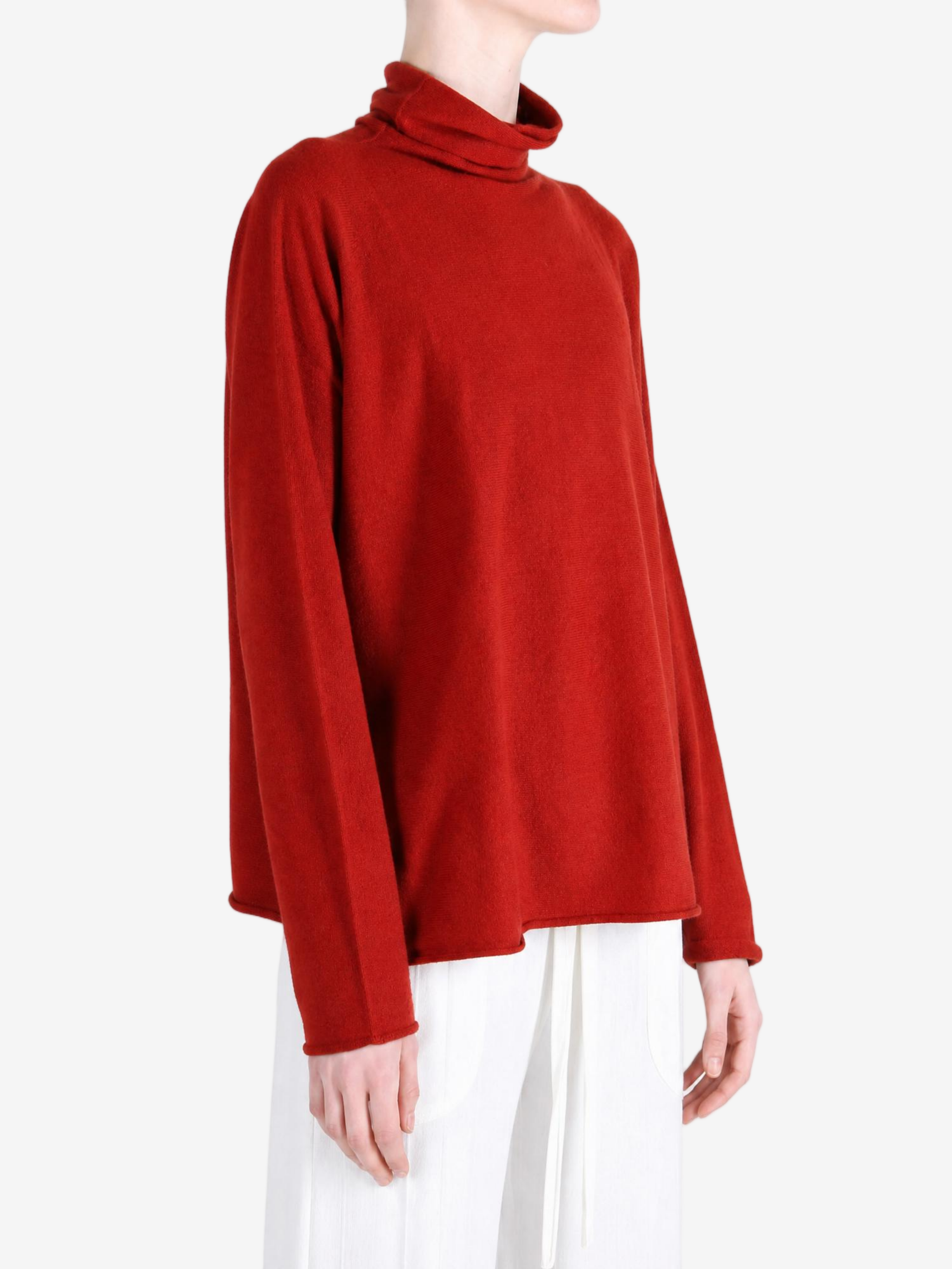 Red knitwear worn by a person, showing the knitwear fit