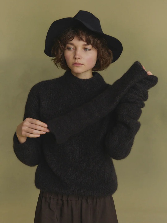 Navy knitwear worn by a person, showing the knitwear's fit