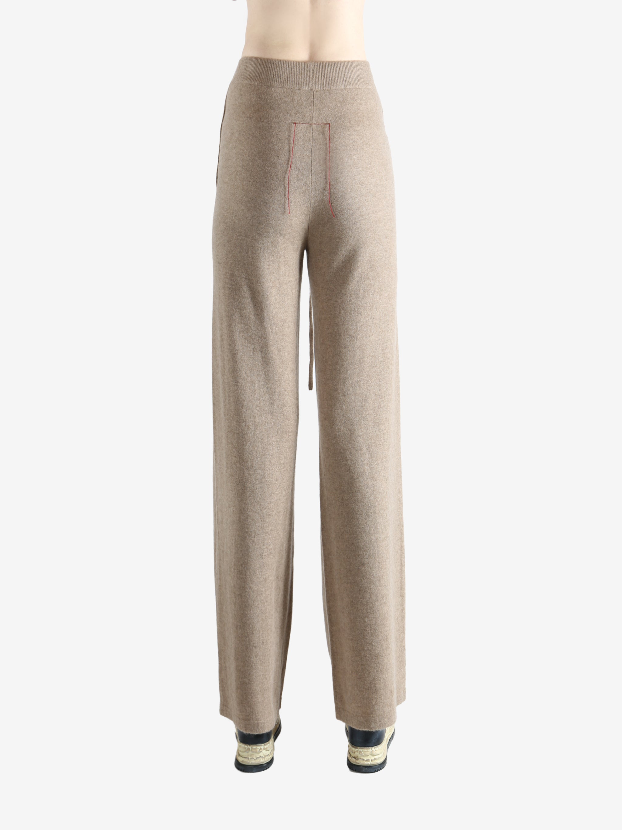 Beige pants worn by a person, showing the pants fit